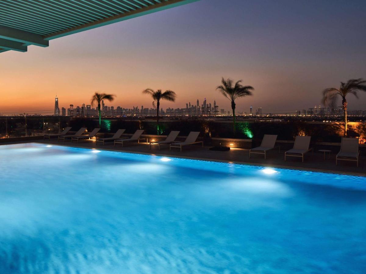 Movenpick Jumeirah Village Triangle ドバイ エクステリア 写真 The swimming pool at the hotel
