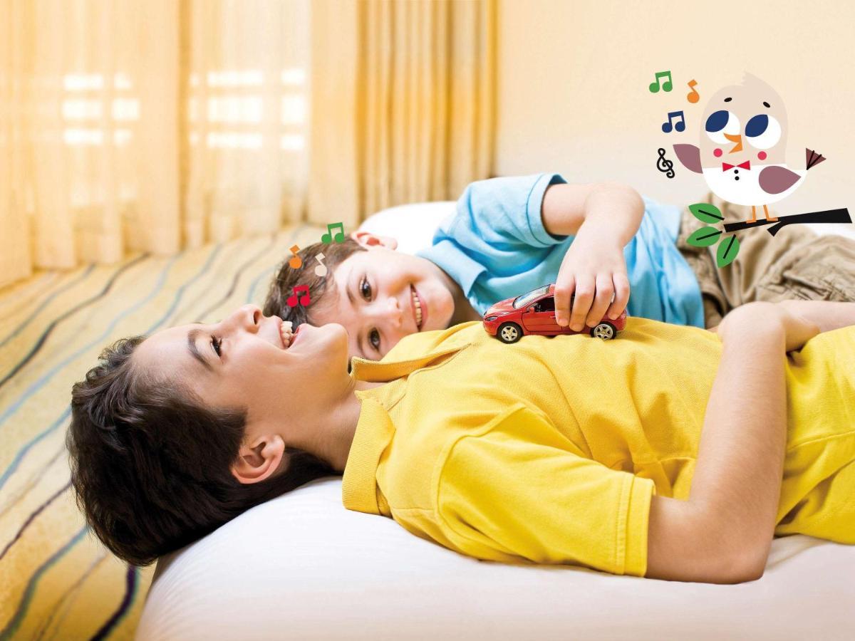 Movenpick Jumeirah Village Triangle ドバイ エクステリア 写真 A child with autism playing with a toy car